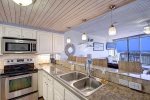 Charming coastal kitchen with stainless appliances